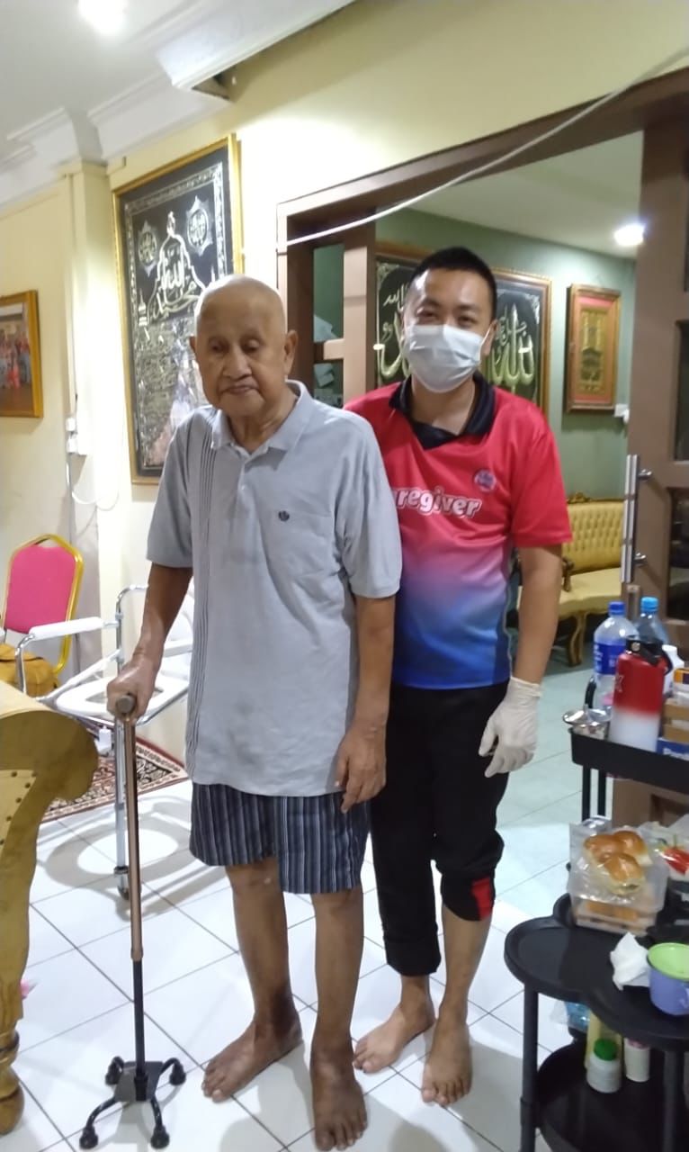 A caregiver assisting an elderly person